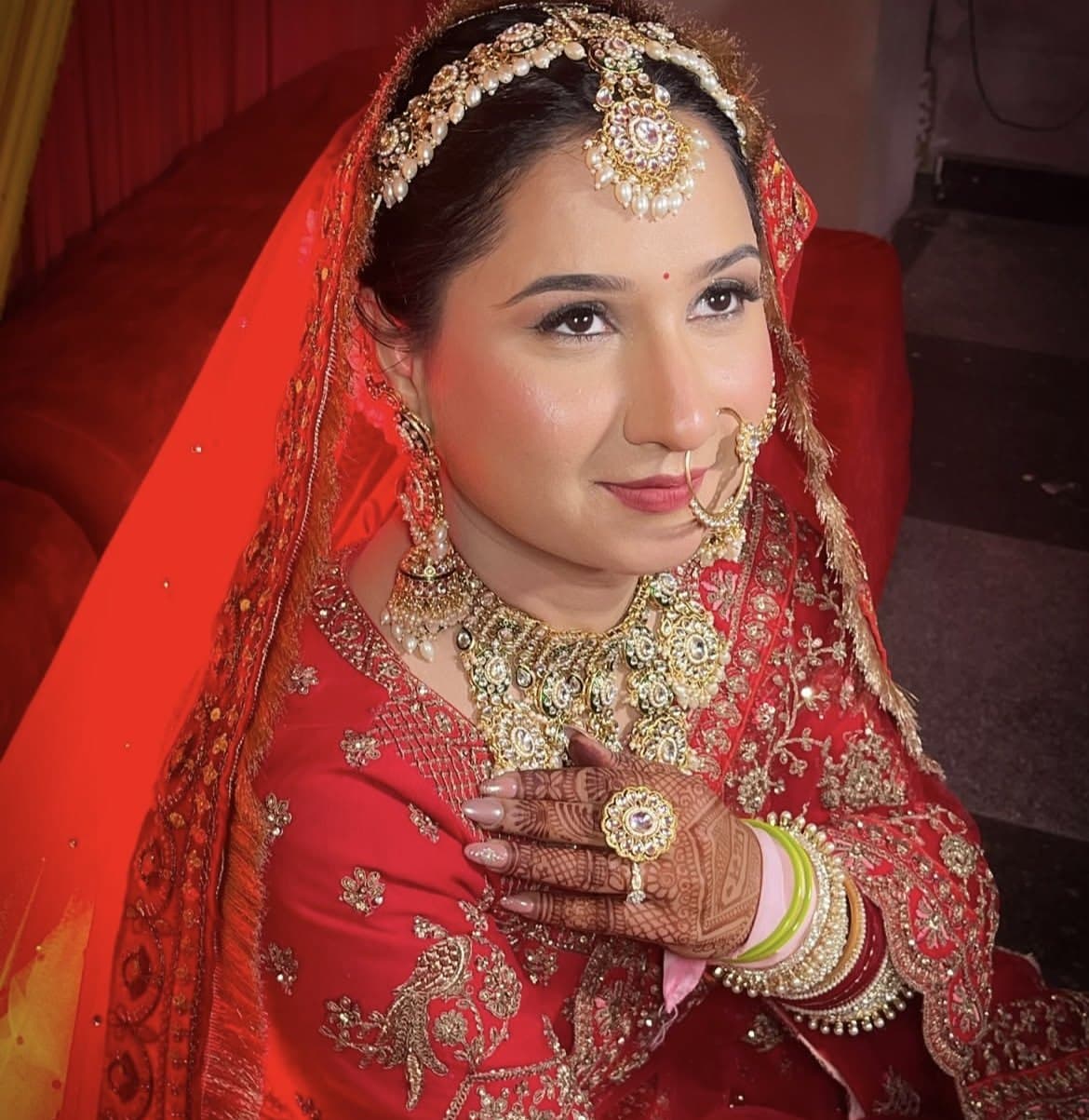 Close-up of bride with kundan maang tikka, nath and long-wear bridal base