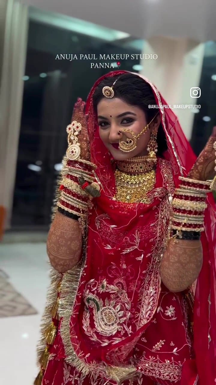 Rajputi bride in red poshak with traditional nath and bangles