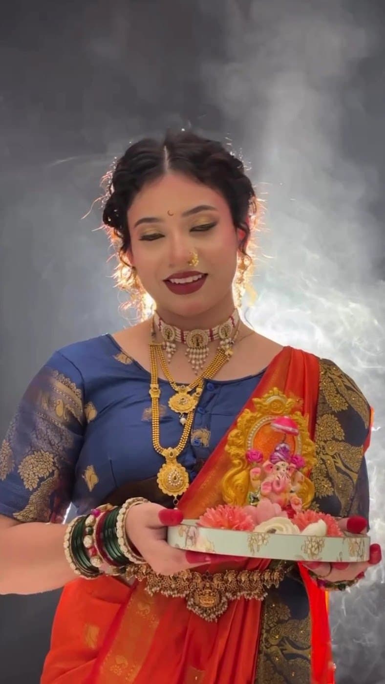 Festive traditional makeup in a silk saree with puja thali