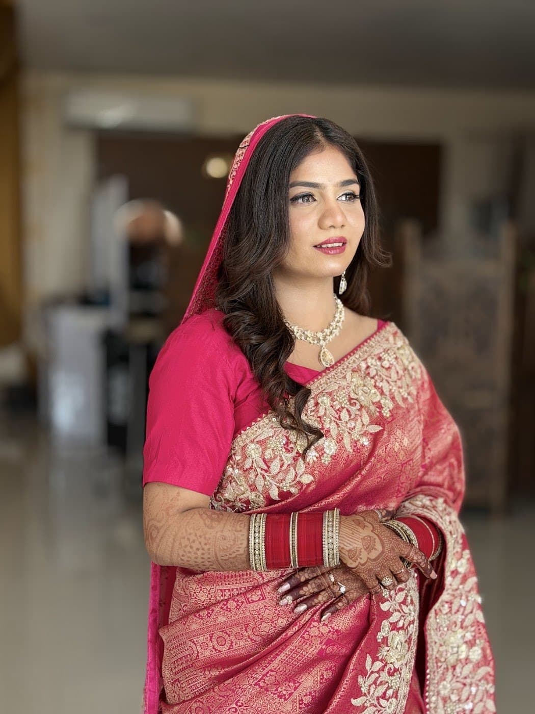 Reception makeup with a pink Banarasi saree and soft waves