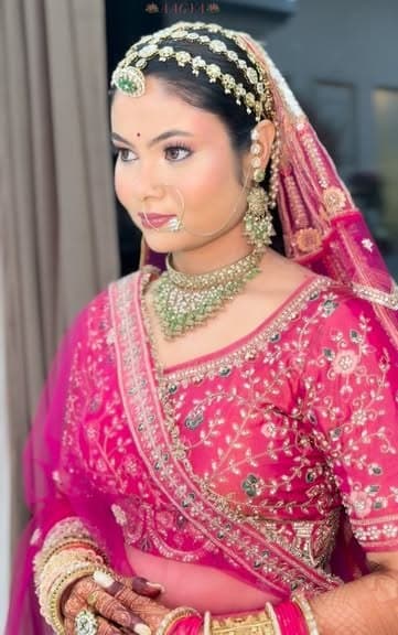 Bride wearing a layered matha patti and pink lehenga